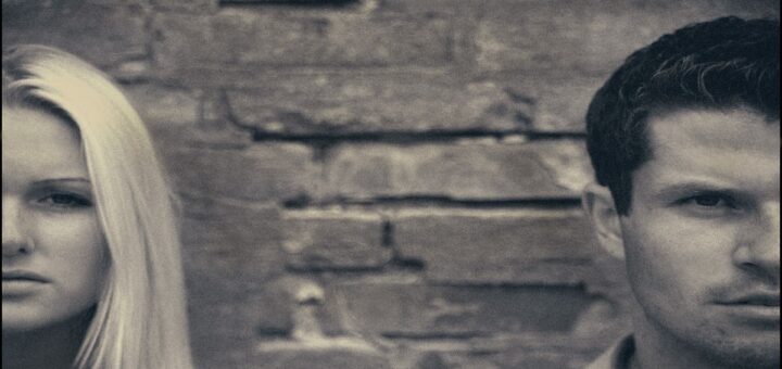 Fights in relationship: half faces of a couple at two opposite ends of the image